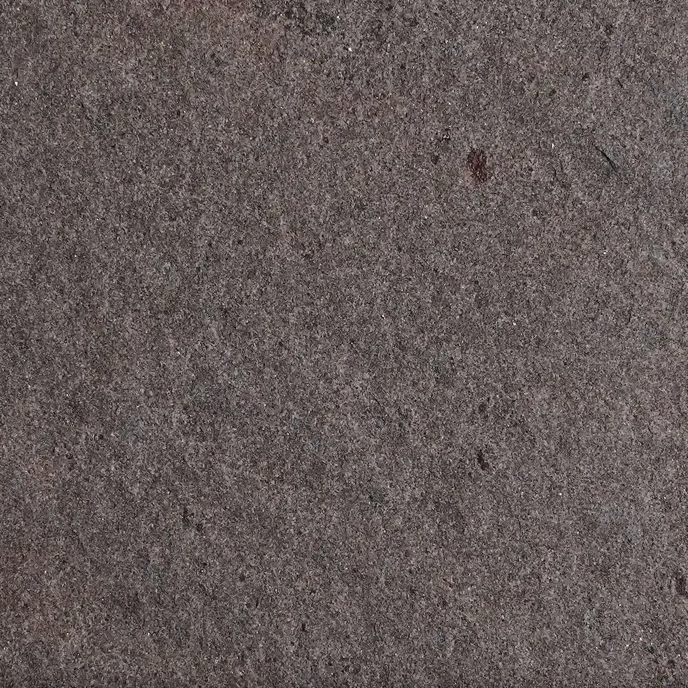 Flamed finish on Violet quartz arenite for plinths and exposed facade zones