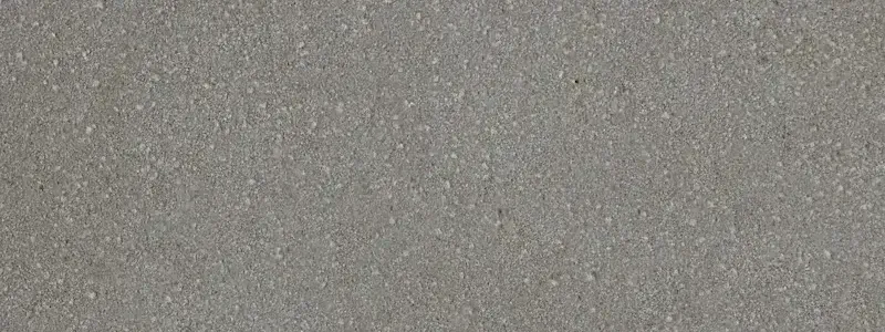 Acabado arenado sobre arenisca Rubio, relieve fino y orgánico obtenido por chorro de arena